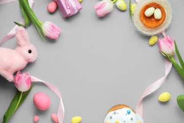 Canvas Print - Frame made of Easter eggs, tulip flowers and decorative nest and bunny on grey background