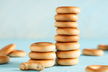 Wall Mural - Stacks of tasty bagels on light blue background