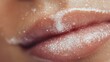 © Nataliia - Close-up of lips with exfoliating sugar scrub and shimmer particles