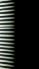 Poster - Abstract light patterns casting dramatic shadows and sharp stripes, generating kinetic visual textures against minimalist black background with graphic design intensity