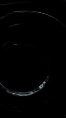 Poster - circular water waves spreading dynamically after droplet striking dark surface, generating intricate