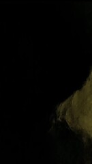 Poster - Golden particles gradually spreading across dark surface, forming dynamic abstract graphic element with cinematic overlay potential