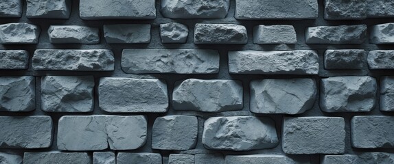 Poster - Textured gray stone wall with irregular bricks creating a rustic and sturdy background ideal for architectural and design themes.
