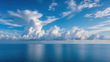 Aufkleber - Serene panorama of fluffy clouds reflecting above a calm blue sea under a clear sky showcasing tranquility and natural beauty.