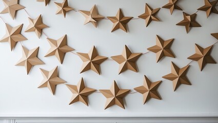 Aufkleber - Cardboard star garland decoration creating a festive ambiance on a white wall for Christmas or holiday celebrations.