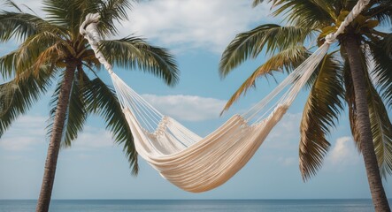 Wall Mural - Relaxing Beach Scene with White Hammock Swaying Between Two Palm Trees Under Clear Blue Sky Ideal for Travel and Vacation Themes
