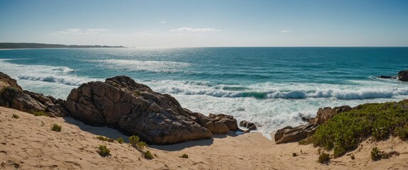 Wall Mural - Breathtaking Coastal Landscape with Rocky Shoreline and Gentle Waves Under Clear Blue Sky