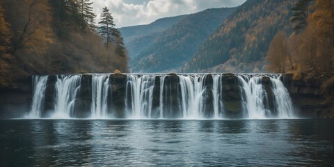 Poster - Majestic Waterfall Cascading Into Serene Lake Surrounded By Autumn Foliage Under Dramatic Sky With Space For Text And Branding