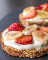 Wall Mural -  delicious toast topped with creamy ricotta, fresh strawberry slices, and banana slices, perfect for a sweet and healthy breakfast