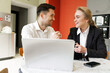 © muse studio - Business colleagues enjoy a coffee break while discussing ideas at a modern office workspace