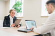 © muse studio - Business professionals engage in a productive meeting at a modern office setting during daytime