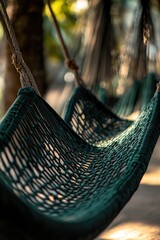 Poster - A green hammock hangs from a tree branch, ready for relaxation