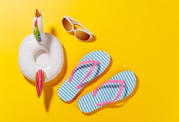 Poster - A vibrant summer vacation scene with flip flops, shades, and a floating flamingo