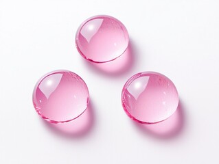Poster - Three pink transparent round liquid drops floating on white background