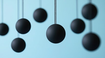Poster - Suspended black spheres in a tranquil blue background, forming an abstract and contemporary design that adds a modern touch to digital presentations or creative projects