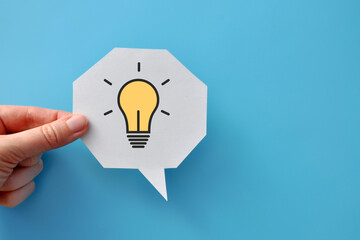 a speech balloon with a light bulb pattern on it. a symbol of the emergence of a creative idea