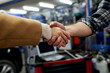 © DusanJelicic - Mechanic shaking hands with satisfied customer after completing vehicle repairs, showcasing trust and confidence in the quality of service at the auto repair shop