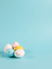 Aufkleber - White Circle Decorated Easter Eggs In Shades Of Yellow, Blue, And Pink Sit On A Soft Pastel Blue Background With Empty Space Around Them.