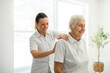 © Louis-Paul Photo - physiotherapist helping senior woman in clinic. Elderly woman undergoing physiotherapy treatment for injury