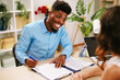 © djile - Consultant explaining contract terms to a client during a business meeting
