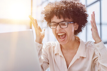 Wall Mural - a girl works in an office at a laptop. gets angry, expresses dissatisfaction