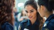 © Murda - Smiling female police officers talking together in a group.