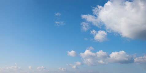 Wall Mural - blue sky panorama with fluffy cumulus clouds and copy space at the left side