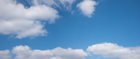 Wall Mural - blue sky panorama with fluffy cumulus clouds and copy space in the middle and right side