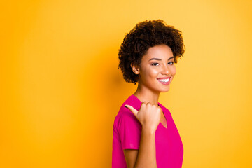 Wall Mural - Copyspace photo of cheerful charming cute attractive youngster pointing at sales started at shopping mall with her thumb isolated over vivid color background