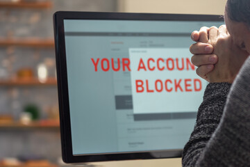 Poster - Closeup of online shopping male customer having problems with payment by blocked bank account, A man contemplates a frozen monitor, illustrating the challenges of account management
