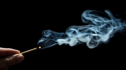 Aufkleber - A hand delicately holds a matchstick ignited at one end, releasing wisps of soft gray smoke that swirl gracefully against a dark background. This ephemeral display captivates the viewer