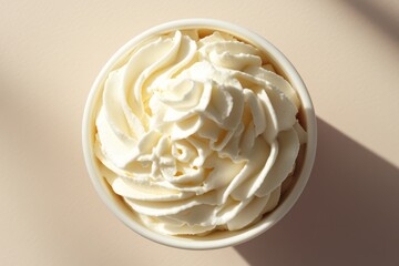 Poster - Creamy delight in a bowl aerial view of fluffy whipped topping on a light beige background perfect for dessert concepts and culinary themes