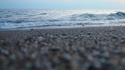 Poster - Observe tranquil beauty as sun sets on horizon, casting soft hues across ocean. Gentle waves ripple peacefully creating a serene atmosphere that invites reflection. Mediterranean Adriatic Sea. Pebbles