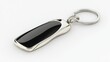 © Boonnam Burart - A stylish car keychain with a luxury brand logo, displayed on a plain white background