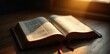 © Waramit - Glowing scripture on wooden desk with light source overhead, wood, natural light, bible