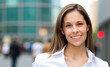 © Minerva Studio - Portrait of a smiling businesswoman in a city setting