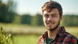 © Andrii - Close portrait of a smiling young Lithuanian male farmer standing and looking at the camera, outdoors Lithuanian rural blurred background