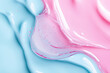 © Mis_TiKa - Serum texture close up. Light blue and pink gradient liquid gel background. Transparent beauty skincare sample. Cosmetic clear liquid cream smudge. Long banner with copy space