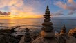 © Ingvar Shelly - coastal sunset with stone pyramids, multiple stone pyramids balanced on a rocky shoreline by the vibrant ocean stretching into the horizon under a colorful sky at sunset