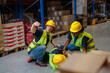 © bernardbodo - Warehouse worker with Down syndrome drawing attention to an injured colleague