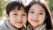 © Lightning - Smiling asian children posing closely together outdoors