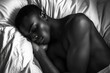 © Olena - Serene Moments: Black Man in Deep Sleep on Cozy Bed with Soft Pillow in Stylish Bedroom