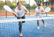 © JackF - Emotional male and female tennis partners hitting ball with rackets on hard court in summer