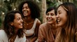 © Postmodern Studio - Diverse group of young women sharing laughter outdoors in nature