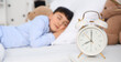 © Pixel-Shot - Cute little boy with alarm clock and toys sleeping in bedroom