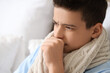 © Pixel-Shot - Sick little boy coughing in bedroom, closeup