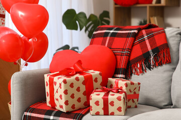 Canvas Print - Interior of living room decorated for Valentine's Day celebration with gift boxes, plaid and heart-shaped cushion on sofa