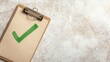 © Danupan - Green Check Mark on Clipboard Over Textured Background Surface