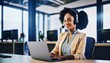 © SSuperTier - Smiling American customer care representative working with headset in office.