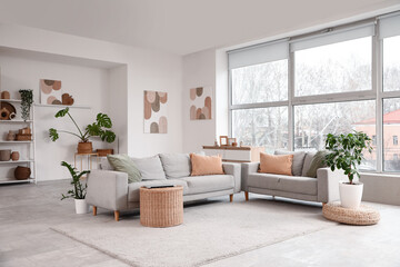 Poster - Interior of living room with comfortable sofas near window